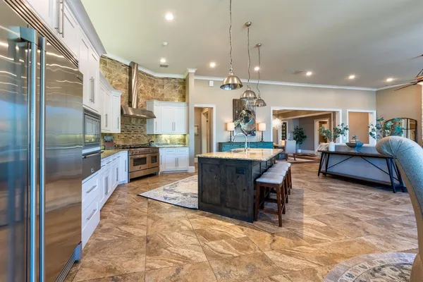 a large kitchen with a table and chairs in it