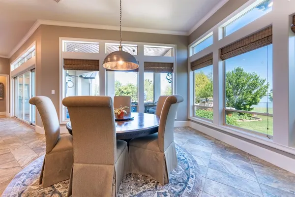 a dining room with furniture a chandelier and wooden floor