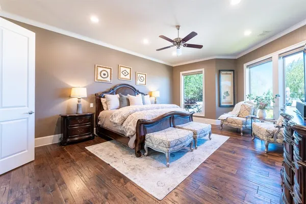 a bedroom with a large bed and a large window