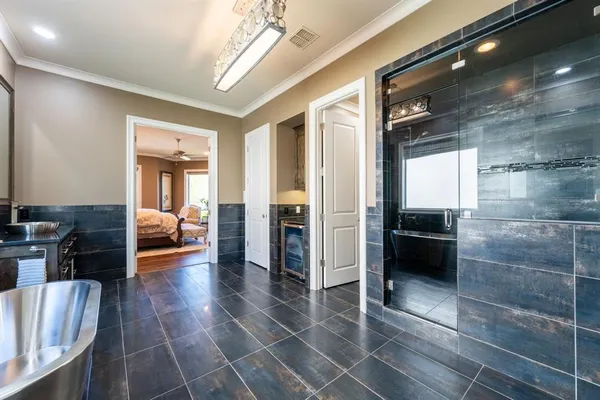 a living room with stainless steel appliances furniture a rug and a view of kitchen