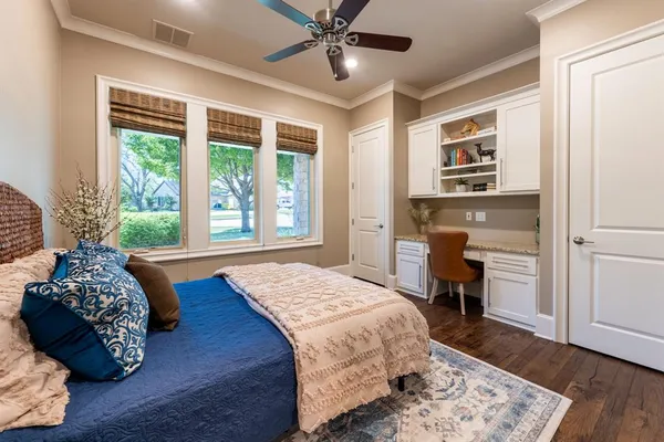 a bedroom with a bed dresser and a window