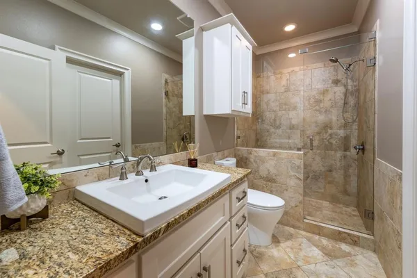 a bathroom with a sink toilet and shower