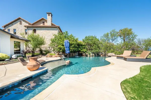 a view of a house with swimming pool and sitting area