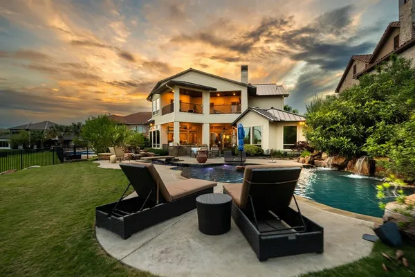 a front view of a house with swimming pool having outdoor seating