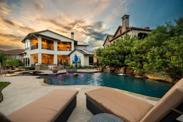 a view of a house with swimming pool and sitting area