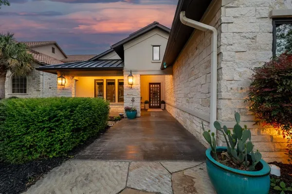 a view of a patio with table and chairs potted plants
