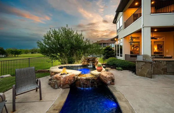 a view of a backyard with sitting area
