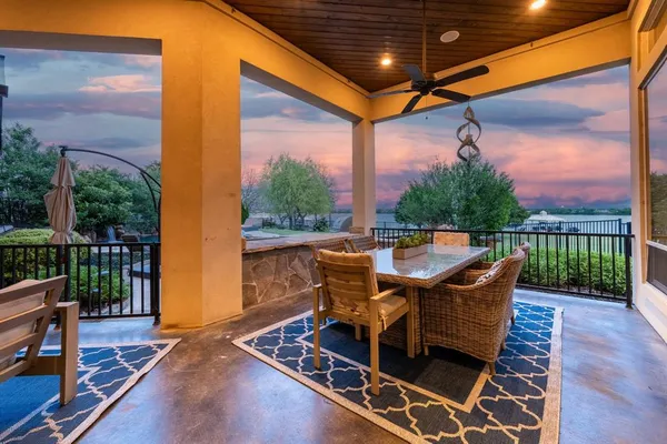a view of a patio with a table chairs and a backyard