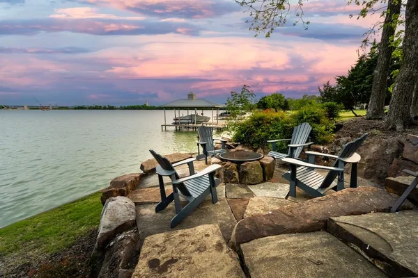 a view of a terrace with furniture and a lake view