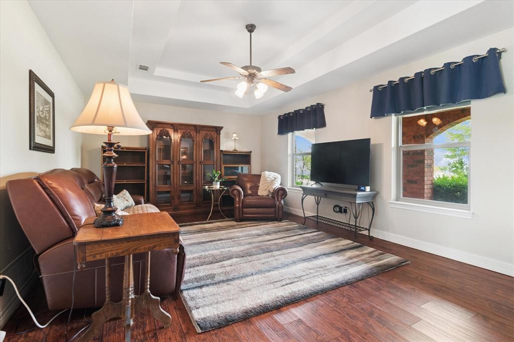 8463 Crestview Road Sanger, TX 76266 - Photo 14 of 36 Living area with a raised ceiling, hardwood / wood-style floors, and ceiling fan