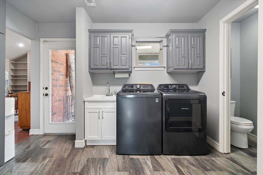 8463 Crestview Road Sanger, TX 76266 - Photo 22 of 36 Laundry room featuring separate washer and dryer, dark wood-style floors, and cabinet space