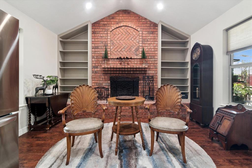 8463 Crestview Road Sanger, TX 76266 - Photo 10 of 36 Sitting room with built in shelves, a fireplace, and dark wood finished floors
