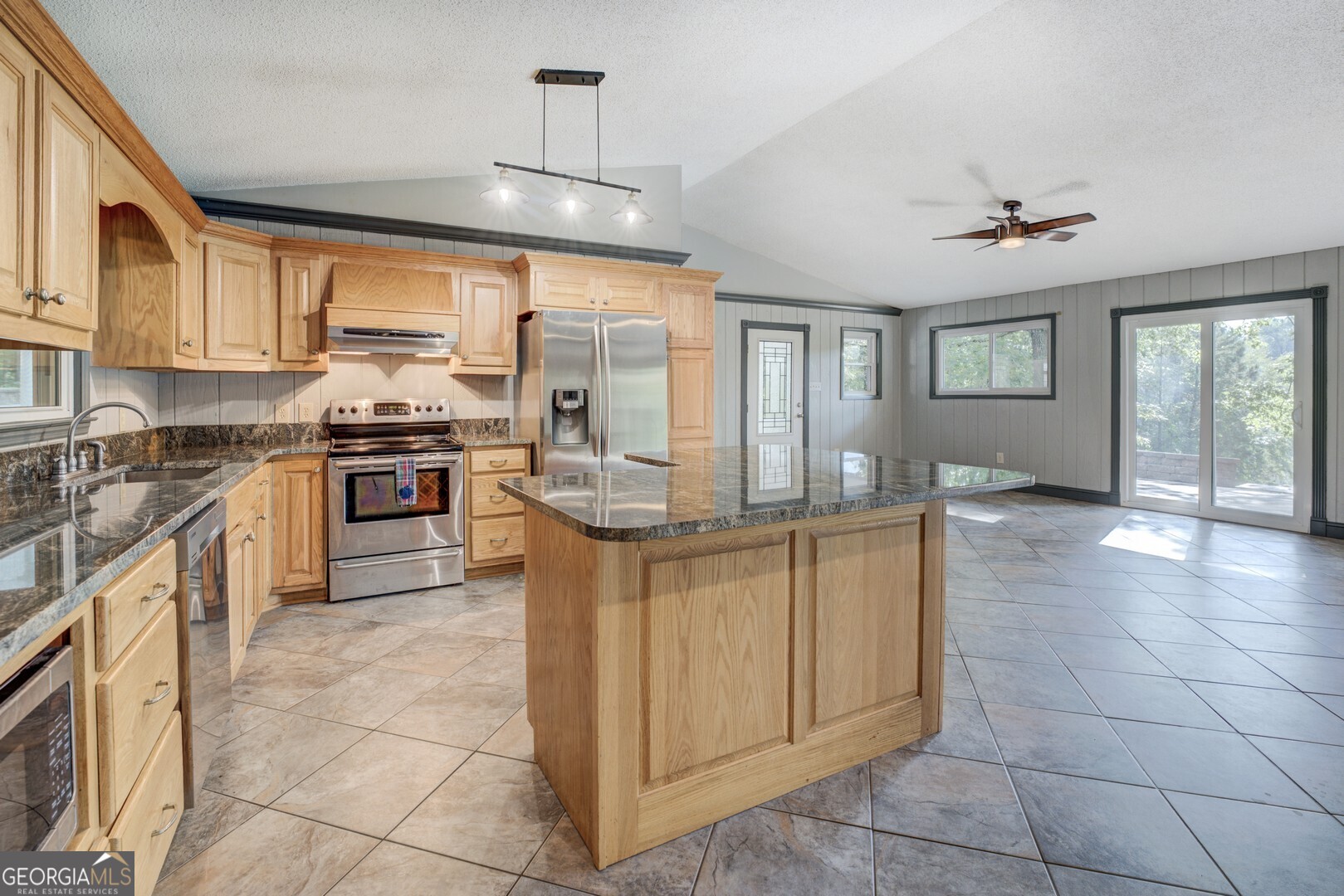 2188 Highway 36 East Jackson, GA 30233 - Photo 12 of 74 a kitchen with stainless steel appliances granite countertop a stove top oven a sink dishwasher a dining table and chairs with wooden floor
