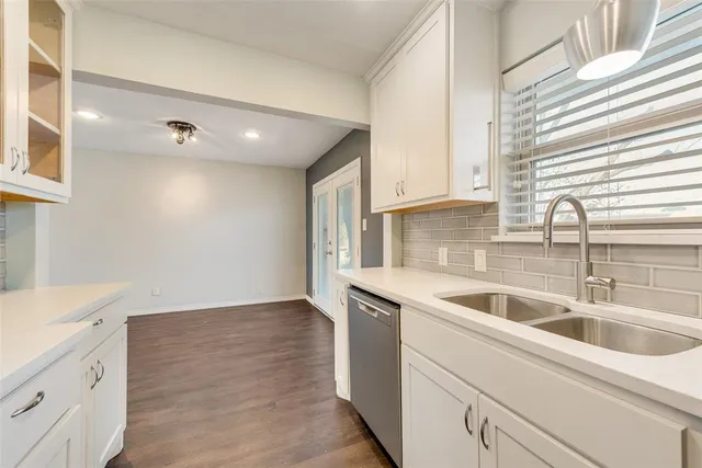 a kitchen with a sink and cabinets