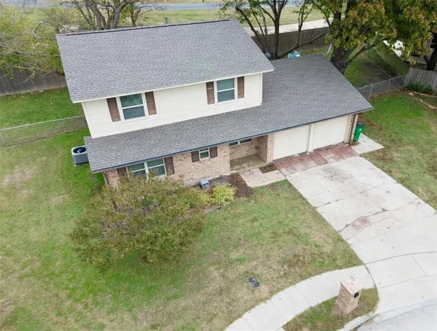 a aerial view of a house next to a yard