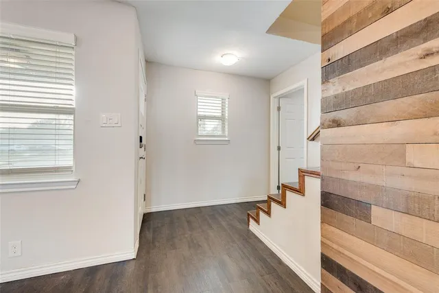 a view of entryway with wooden floor and stairs