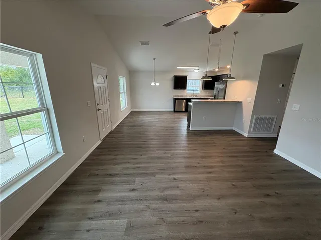 a view of kitchen with sink microwave and refrigerator