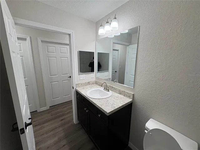 a bathroom with a sink a toilet and a mirror