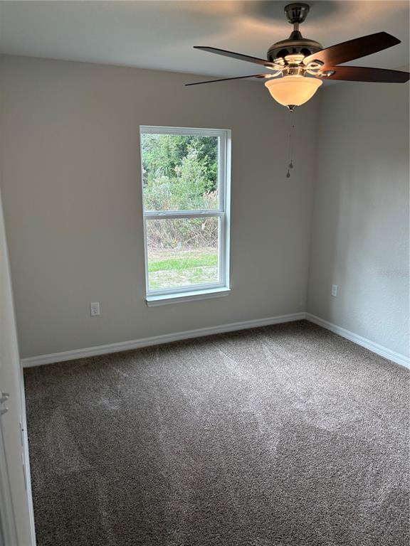 9650 Northwest Gainesville Road Ocala, FL 34482 - Photo 20 of 32 an empty room with windows and fan