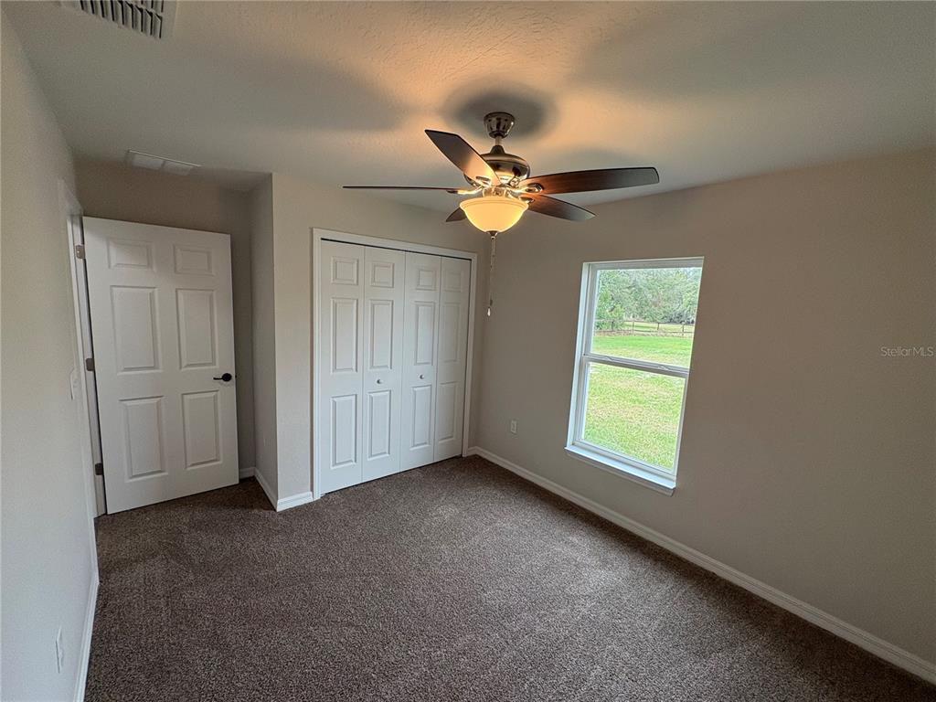9650 Northwest Gainesville Road Ocala, FL 34482 - Photo 25 of 32 an empty room with a window and a fan
