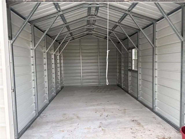 a view of backyard of house with green space