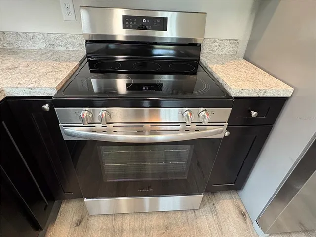 a stove top oven sitting inside of a kitchen