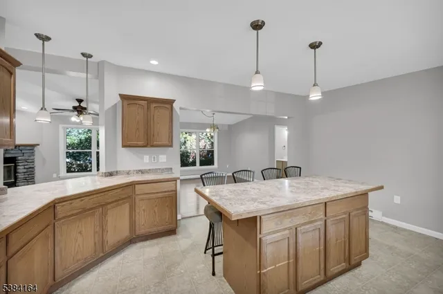 a kitchen with center island and stainless steel appliances