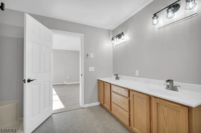 a bathroom with a double vanity sink and mirror