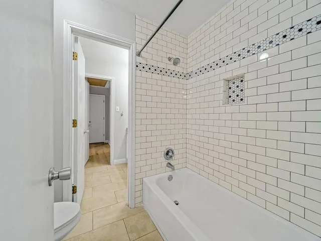 a bathroom with a bathtub and shower