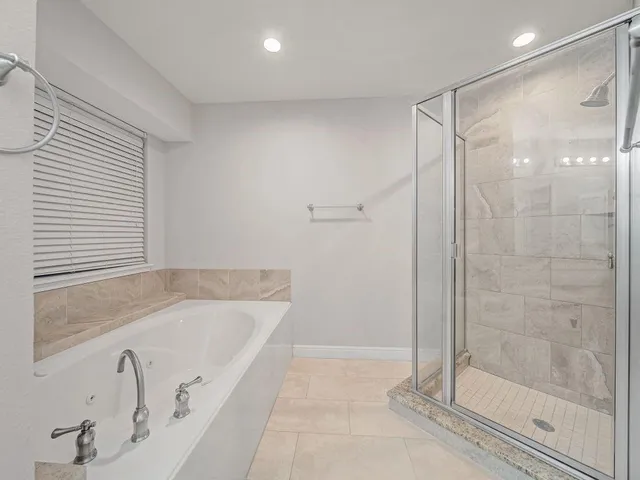 a bathroom with a bathtub and a shower
