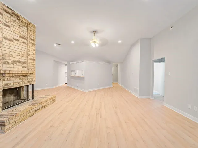 a view of empty room with a fireplace and workspace