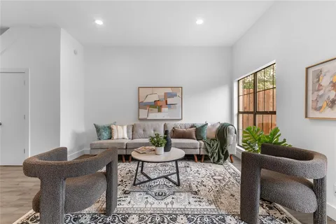 a living room with furniture and flowers