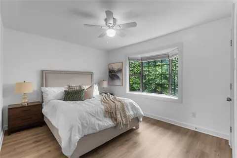 a bedroom with a large bed and a window