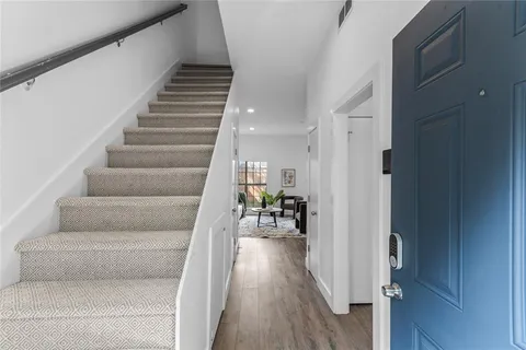 a view of entryway and hall with wooden floor