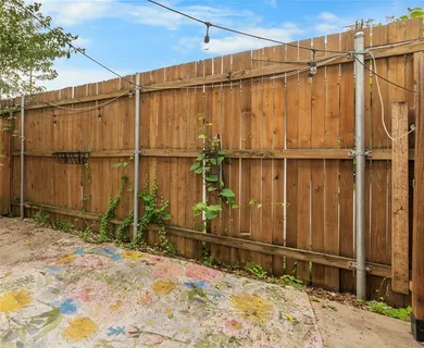 a view of a backyard with wooden fence