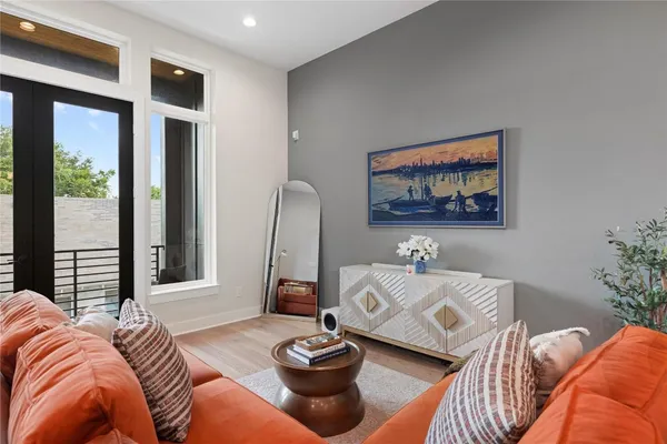 a living room with furniture and a ceiling fan