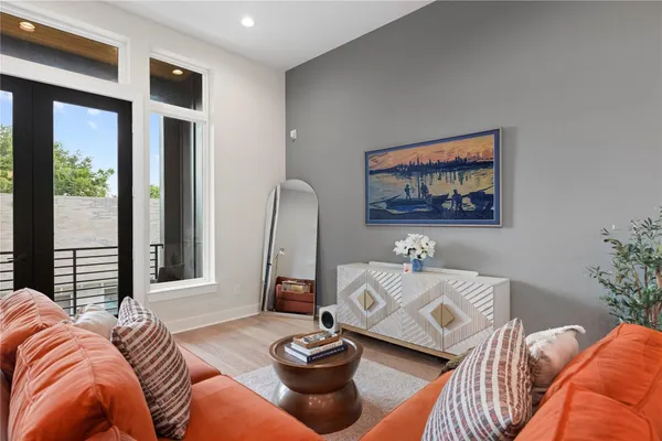 a living room with furniture and a ceiling fan