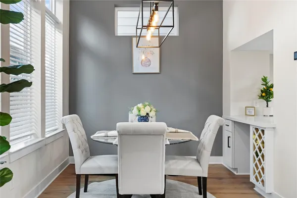 a view of a dining room with furniture wooden floor and chandelier