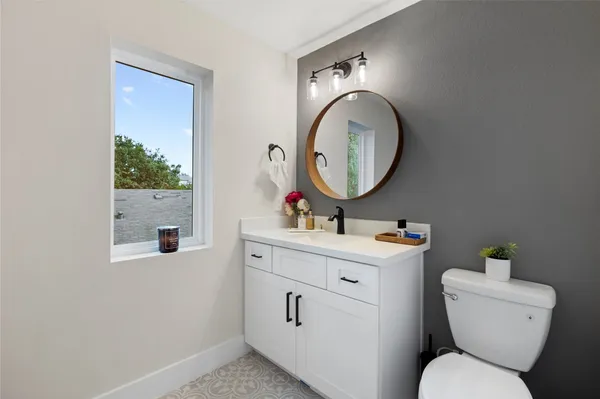 a dining room with furniture potted plants and wooden floor