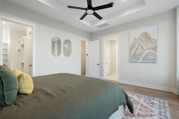 a bedroom with a large bed couch and a large window