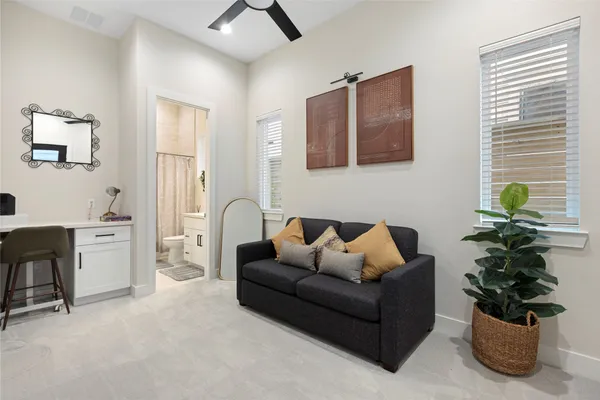 a living room with furniture potted plant and a window