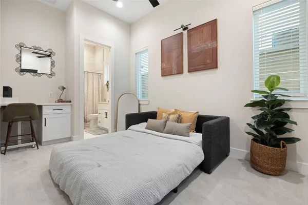 a bedroom with a bed and a potted plant