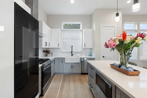 a kitchen with a sink stove and cabinets