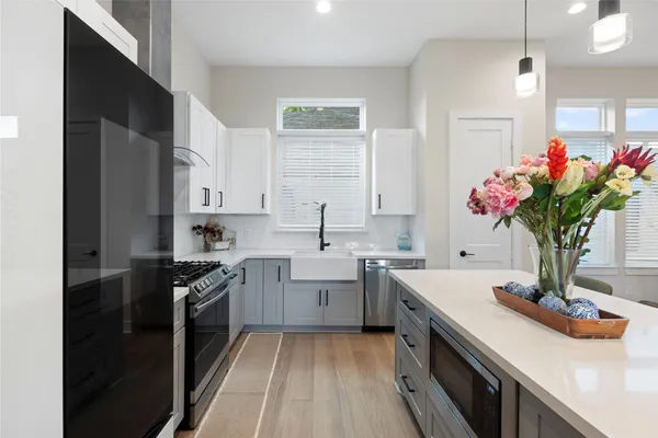 a kitchen with a sink stove and cabinets