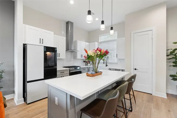 a kitchen that has a table and chairs in it