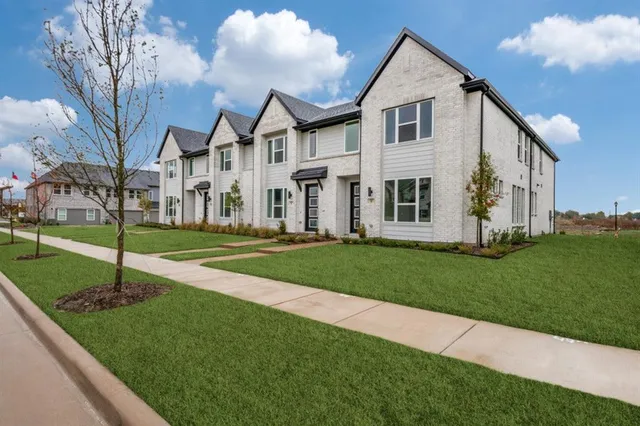 a front view of a house with a garden and yard