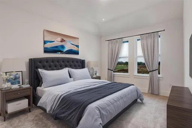 a bedroom with a bed and a painting on the wall