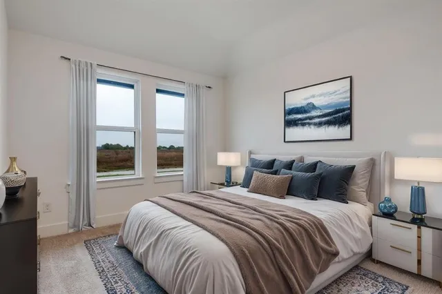 a bedroom with bed and a large window