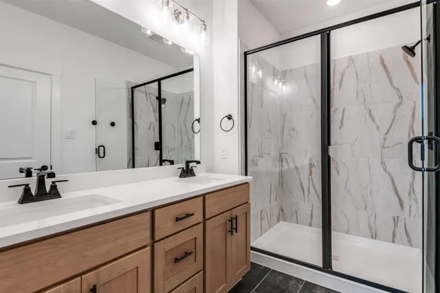 a bathroom with a shower sink and mirror