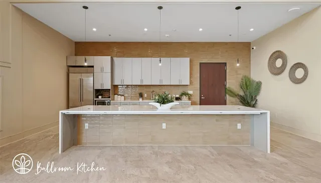 a view of kitchen with kitchen island a sink a stove and a refrigerator